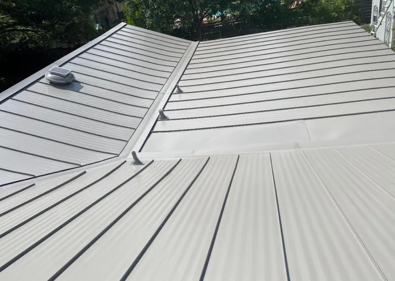 Solar attic fan installed on a metal roof for Roof Ventilation in Fort Edward